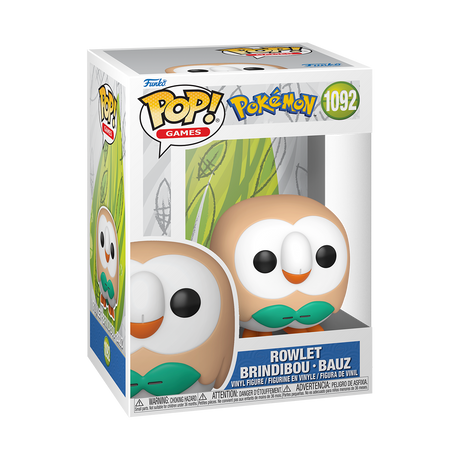 A Funko Pop! Games figure of Pokémon Rowlet, an owl-like creature with a light brown body, white face, green bow tie, and orange beak. The box is white and light blue with a green leaf pattern.