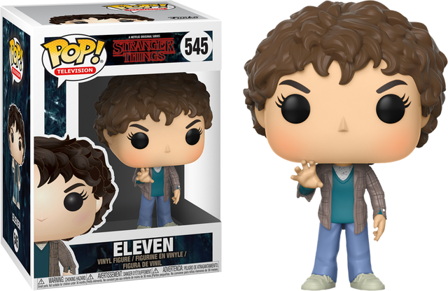 Funko Pop! Stranger Things Eleven (Season 2) figure with a bob haircut, wearing a pink dress and holding a box, from Shak's Pop Shop.